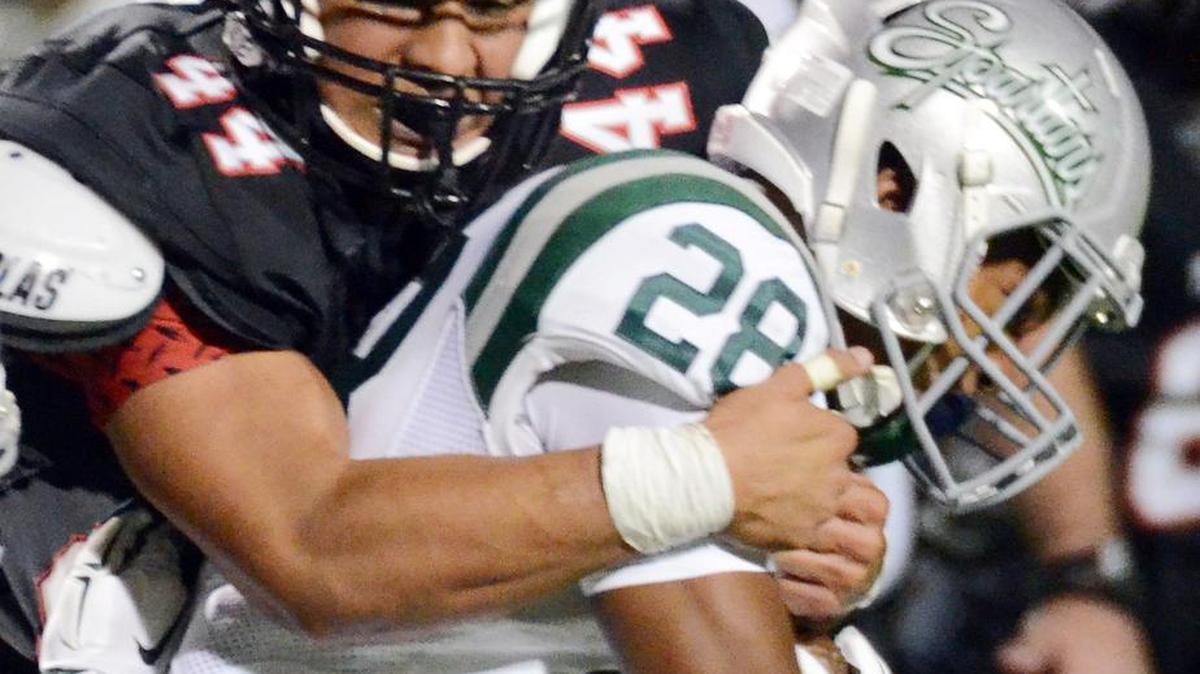 
Trinity's Devin Abdullah tackles De La Salle's Antoine Custer as he takes the ball up the field in the first quarter of Saturday's game.
