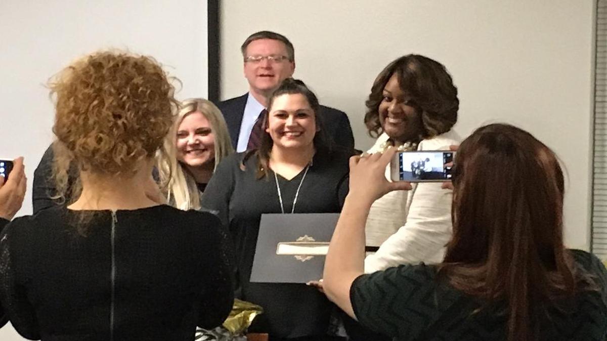 From left: Chrissy Fezzey surrounded by friends, Brittany Griggs, GRACE Transitional Housing caseworker; Mark Moyer, GRACE board member; and Jame Scott, GRACE Transitional Housing manager.