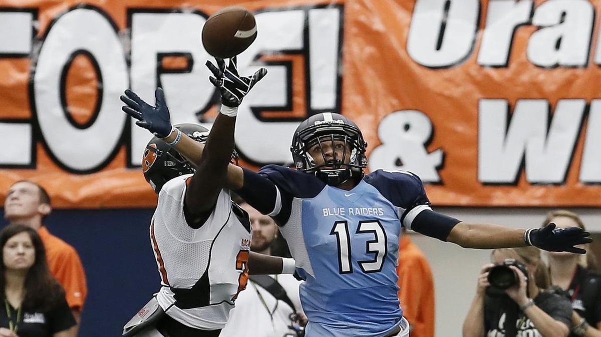 Bell’s Christion Nealy, right, has shifted from wide receiver to safety, and college programs have taken notice.