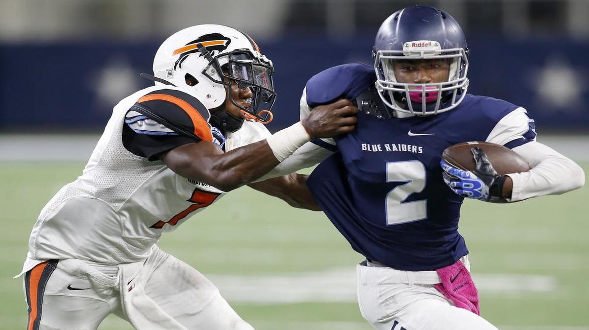 L.D. Bell Raiders receiver Ricky Walton tries to get past a Haltom defender last October.