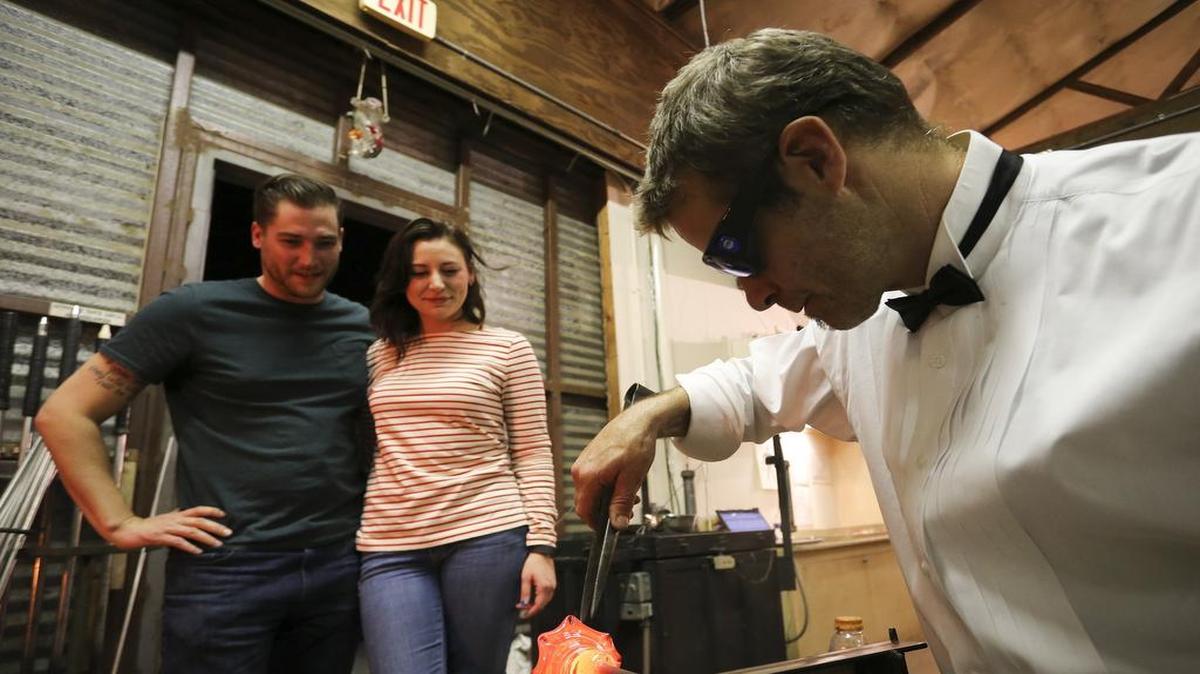 Clayton Sievers and Taylor Farmer watched recently as glassblower Spencer Crouch created the petals on a glass flower.