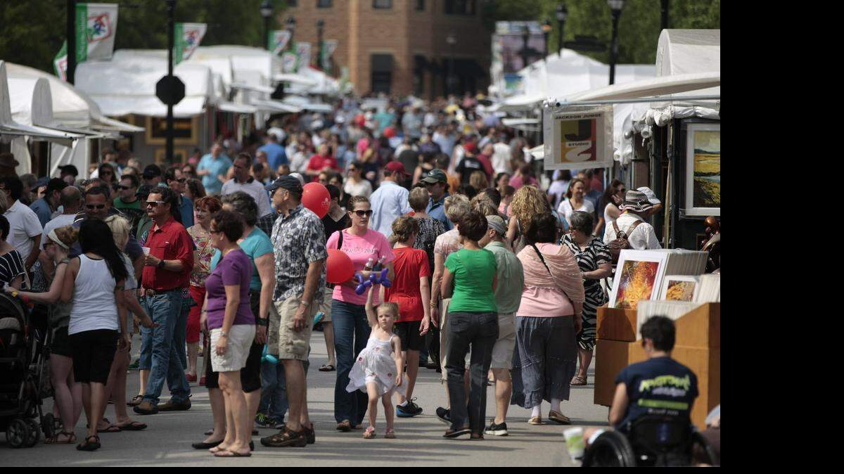 
Crowds move through last year’s Art in the Square at Southlake Town Square. 
