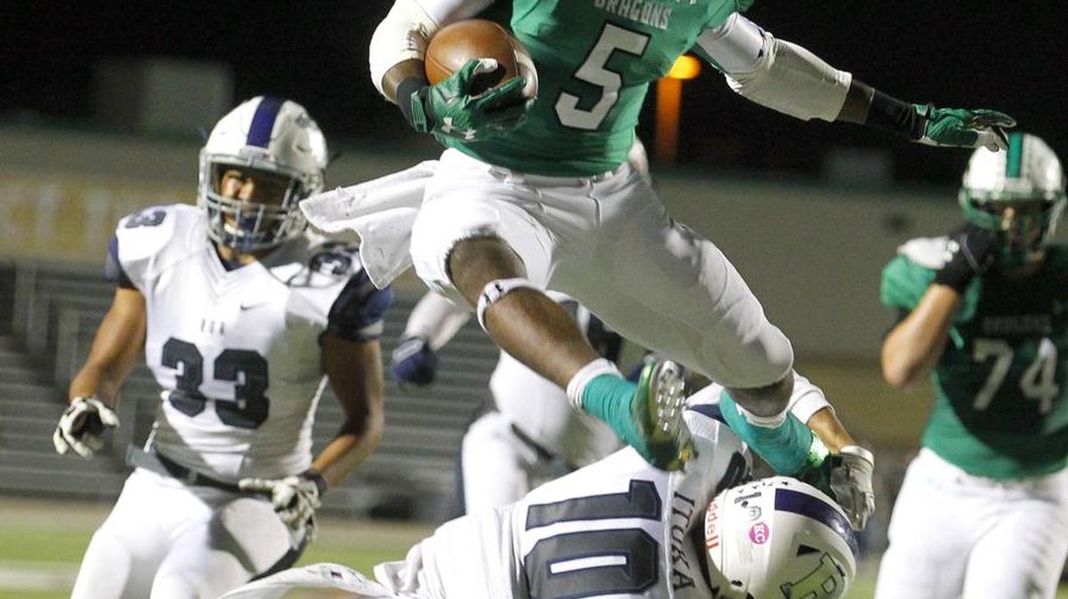 
Carroll’s Shemar Coleman leaps over a Richland defender to score last week.
