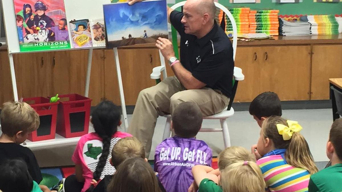 Superintendent David Faltys reads to Johnson students.