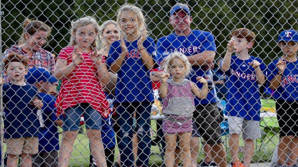 Families gathered to watch a softball game between the Colleyville firefighters and police officers at the annual Colleyville National Night Out at City Park.