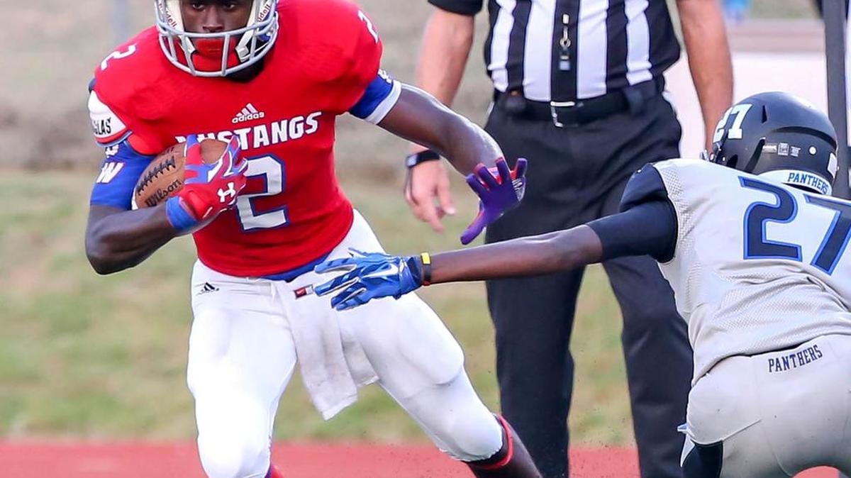 
Grapevine’s RalphLauren McCauley (2) makes a reception, then tries to get past North Crowley's Michael Ussin last Thursday.
