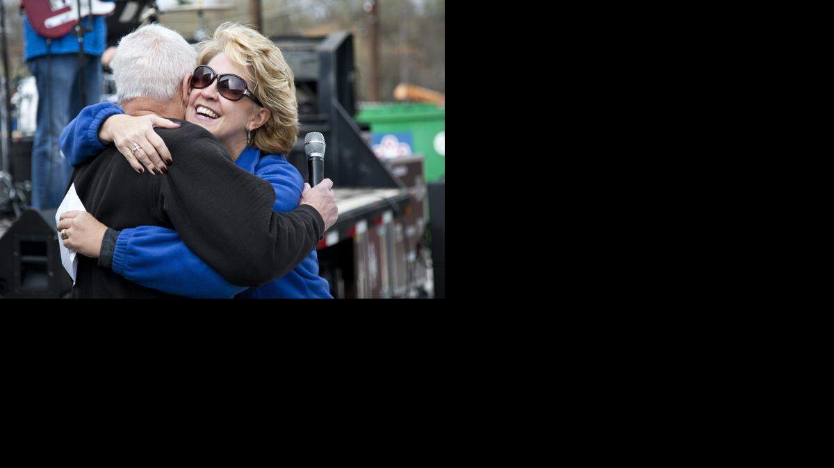 
Shonda Schaefer hugs Joe Luccioni of an area runners group.
