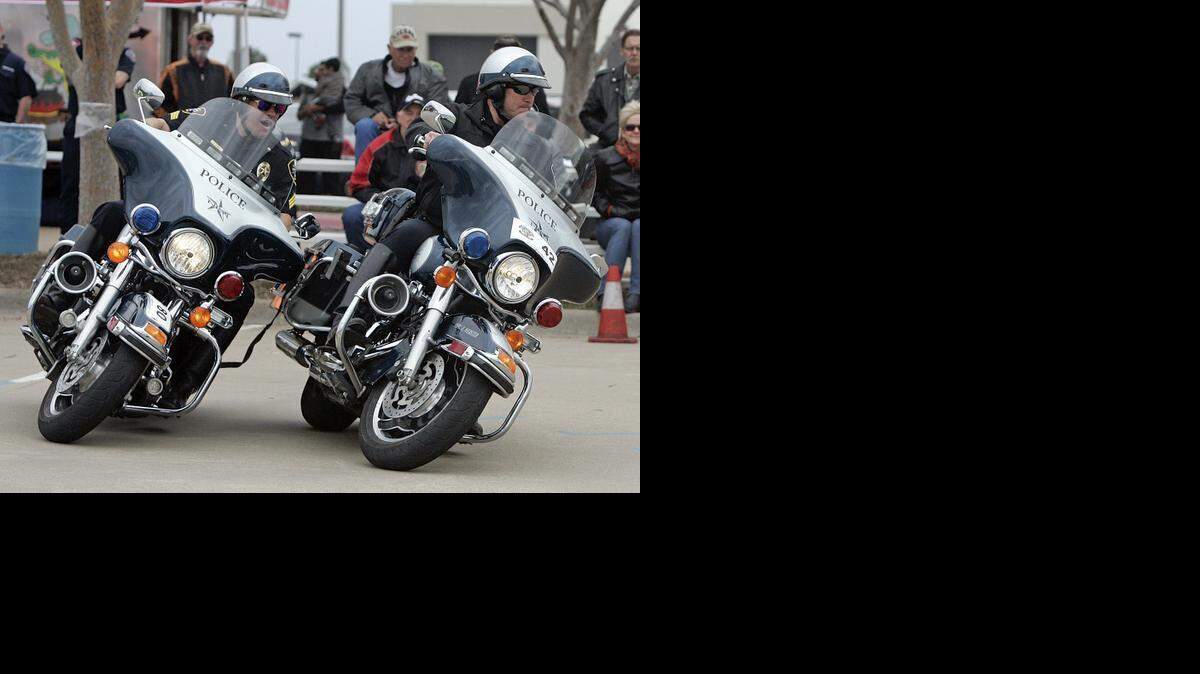 
North Richland Hills Sgt. James George and officer Eric Webster participate in the Two Man Tethered Ride during the Coppell-Grapevine Police Motorcycle Rodeo at Wagon Wheel Park in Coppell Saturday afternoon March 14, 2015. Webster and George won the event with a time of 16:29. The bikes are joined together with a one inch nylon webbing that has velcro break away. Eighty officers from across the state gathered to compete in motorcycle handling maneuvers. 
