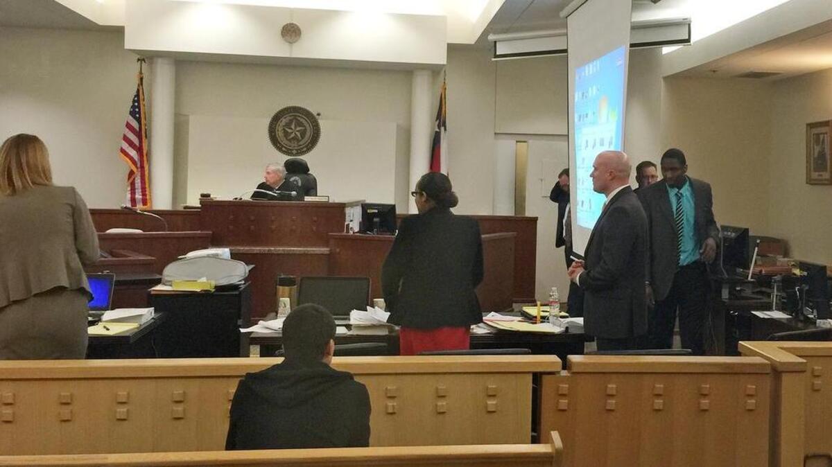 Defendant Robert Williams, right in teal shirt, is led into court on Tuesday for trial in the death of his 3-year-old daughter, Anastasia.