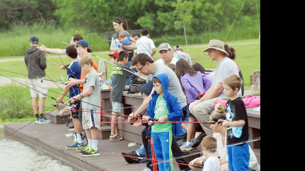 
Kids with their parents cast their fishing lines into the pond at Bob Jones Park to catch Channel Catfish during the Southlake Youth Fishing competion Saturday, May 9 2015 in Southlake. Approximately 100 children participated in the event that had to end early due to weather. 
