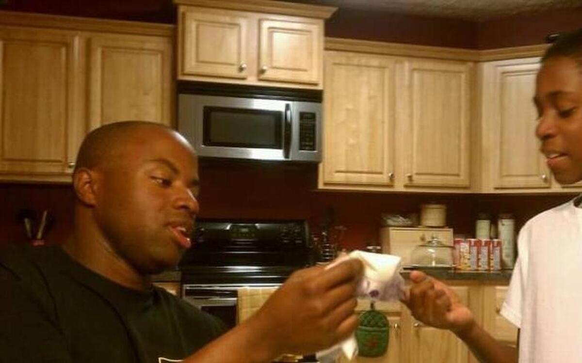 Michael Jones, right, with stepson Jahari Hill as a child.