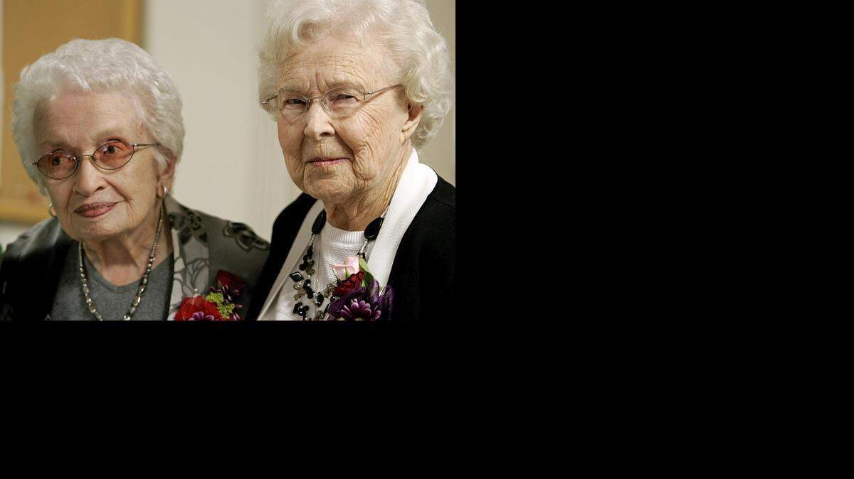 
Martha Wood and Millie Stuck stand together as friends and family take their photos during a birthday party at the Southlake Senior Center Friday afternoon March 27, 2015. 
