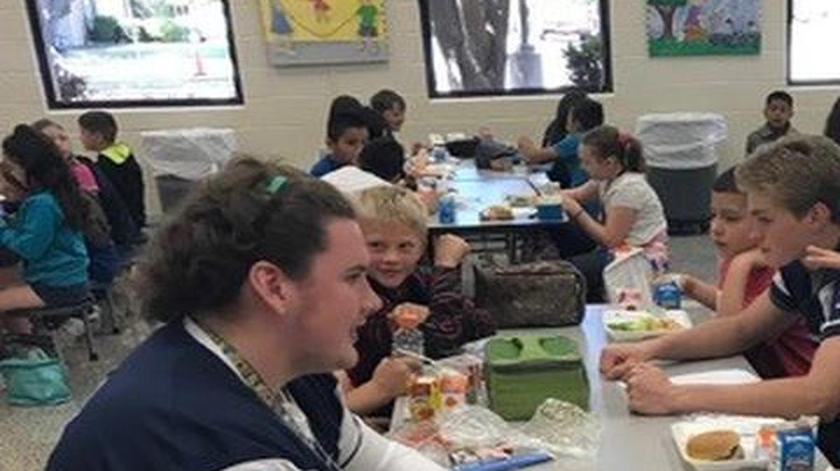 Bell football players eat lunch with fourth graders as part of the “Make an Impact” initiative.