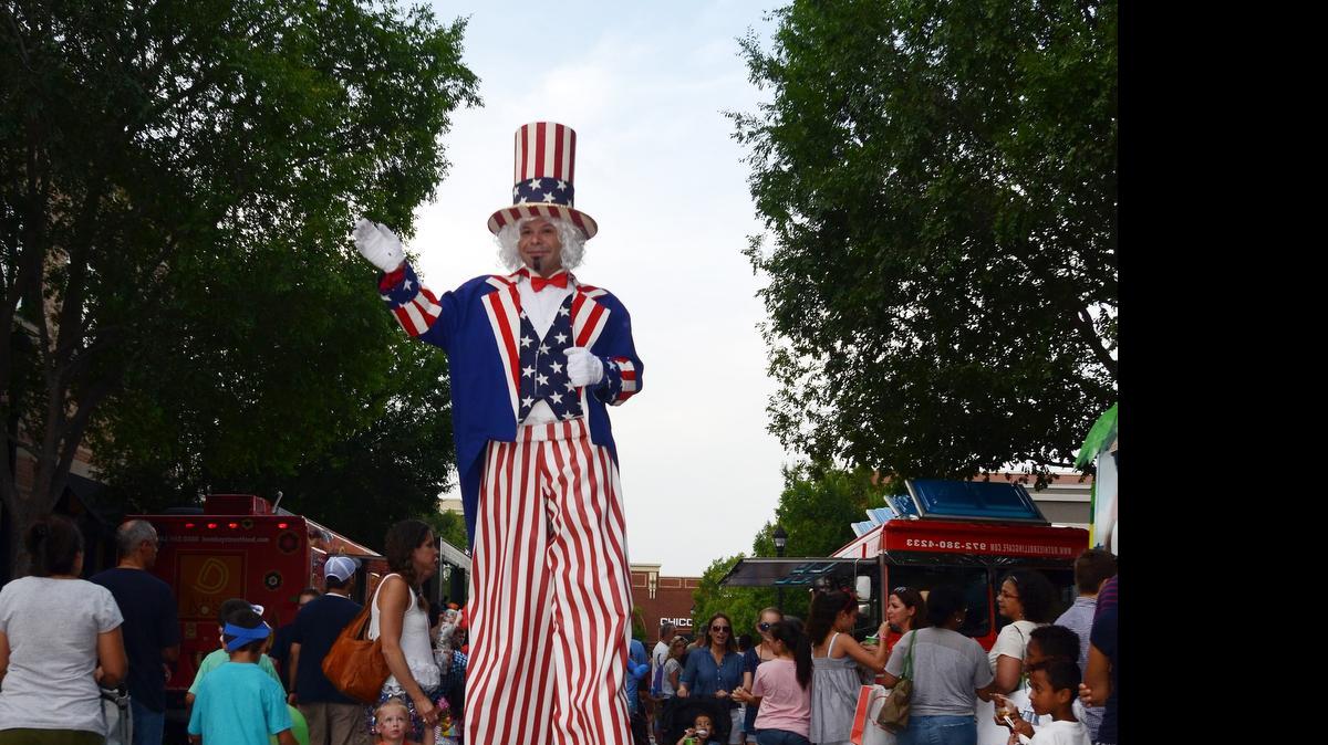 
Joe Avila as Uncle Sam walks among the crowds at Southlake Town Square.
