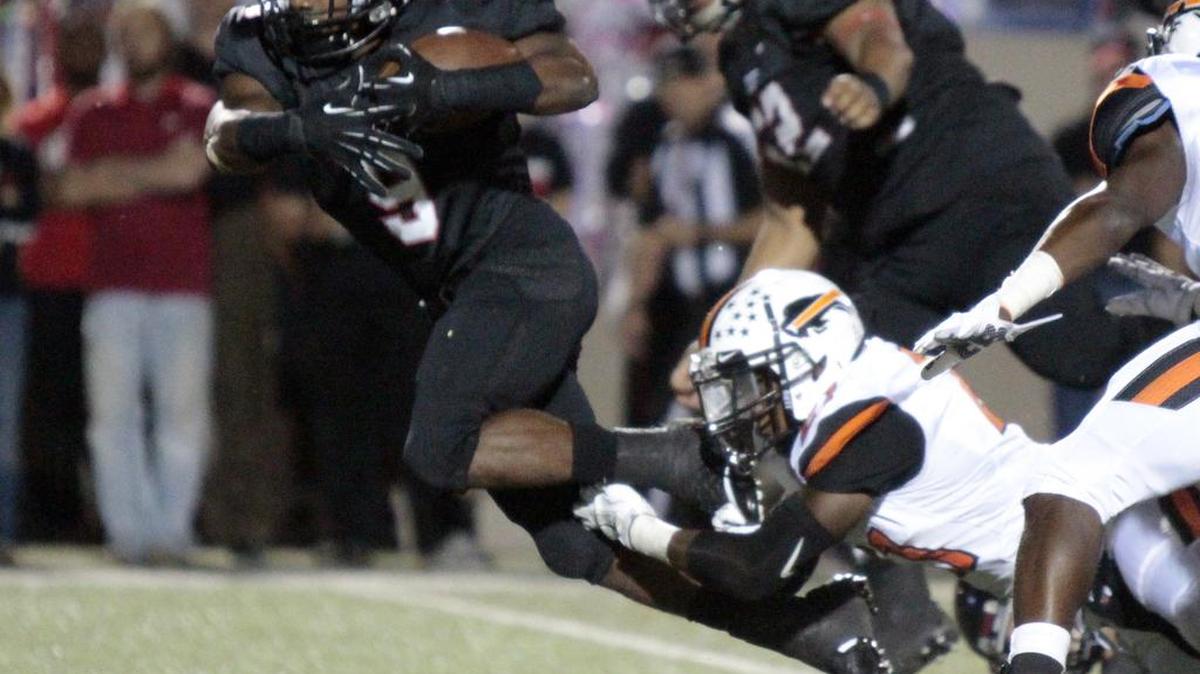 
Trinity senior RB De'Jaun Garrett (9) escapes a tackle as Trinity High defeated Haltom High last week.
