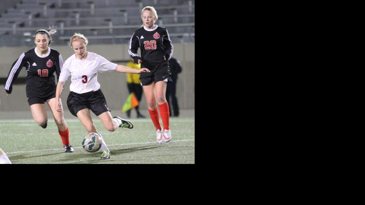 
Trinity’s Kaycee West (No. 3) splits two Coppell defenders in recent district action.
