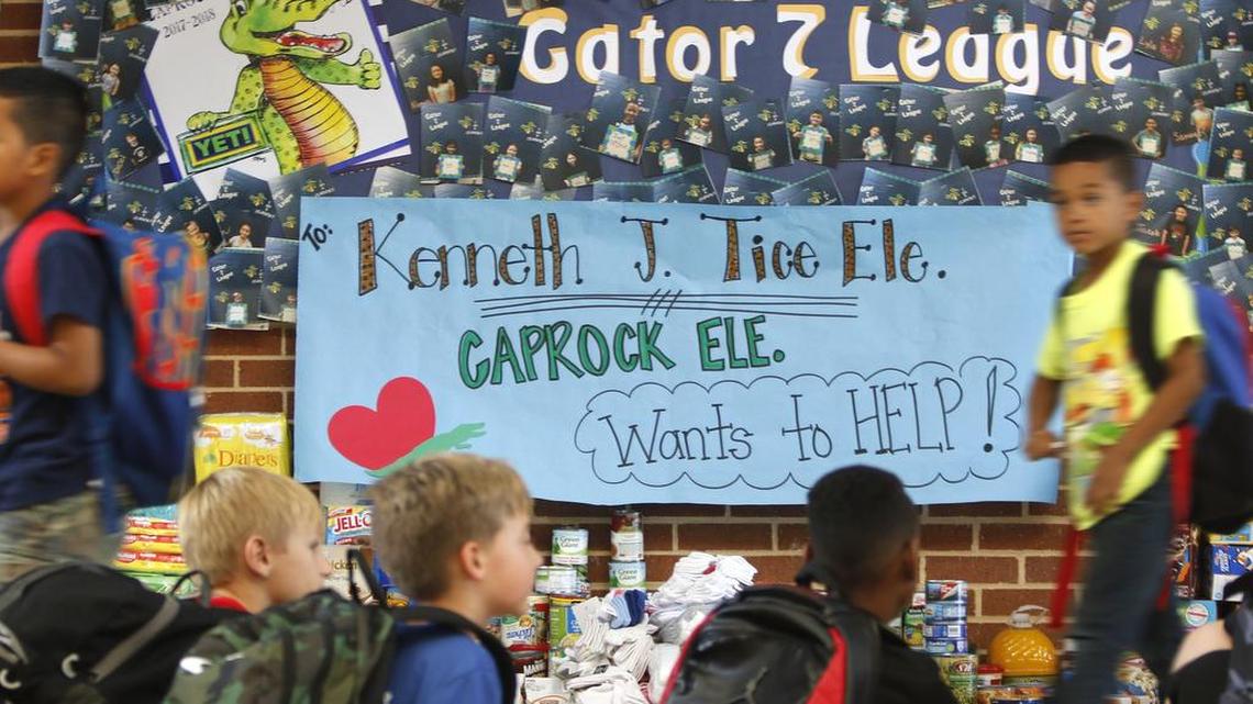 Students pass by the display for the Principals helping Principals project at Caprock Elementary School in Keller.