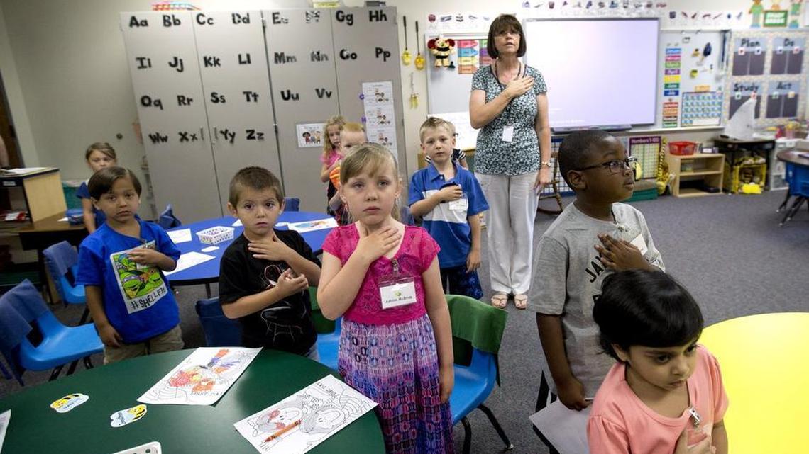 Kindergarten teacher Sherry Uribe leads her students in the pledge of allegiance to start off the first day of school at Shady Brook Elementary School in Bedford on Monday, Aug. 24, 2015. Teachers in the Hurst-Euless-Bedford district are at or near the top in salaries for area school districts.