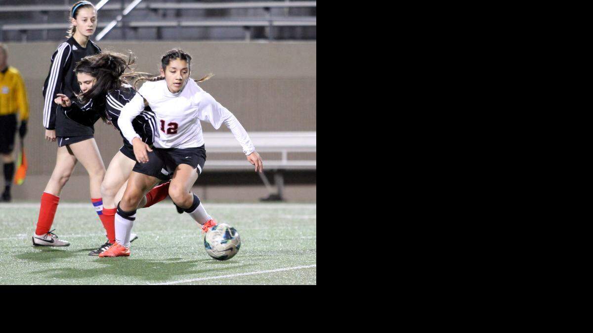 
Nadia Garcia (No. 12) works the ball away from a pair of Coppell players in last Friday’s game.

