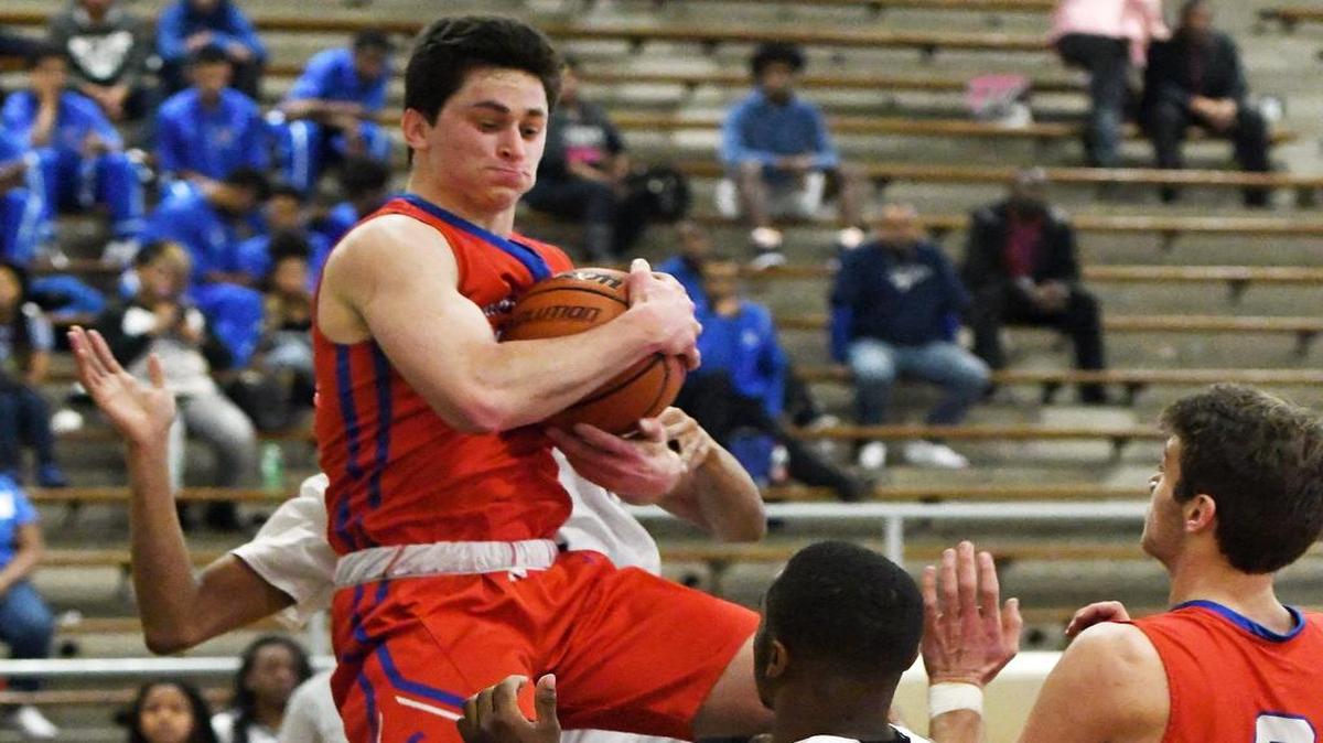Grapevine's Boone Montgomery, left, grabs a defensive rebound in Saturday’s victory over Dunbar.