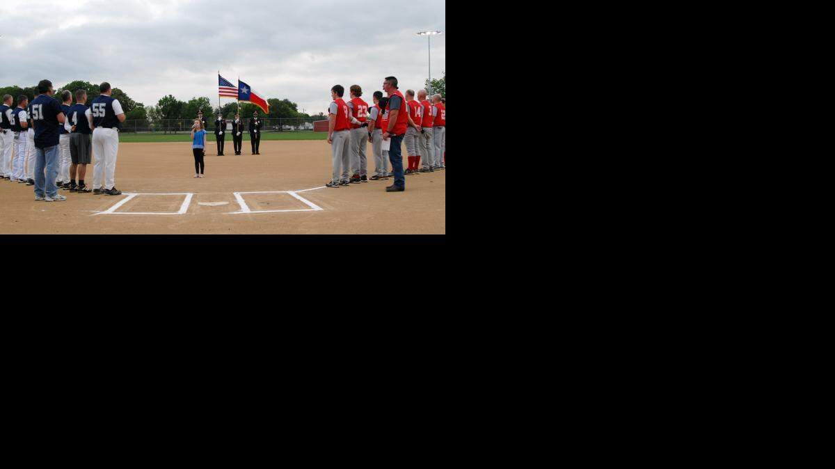 
Peyton Lain, 9, center, sings the National Athem before the start of the Grapevine Police vs Fire Softball Challenge to benefit the Grapevine Shield Foundation Saturday April 11, 2015, at Oak Grove Park in Grapevine. 
