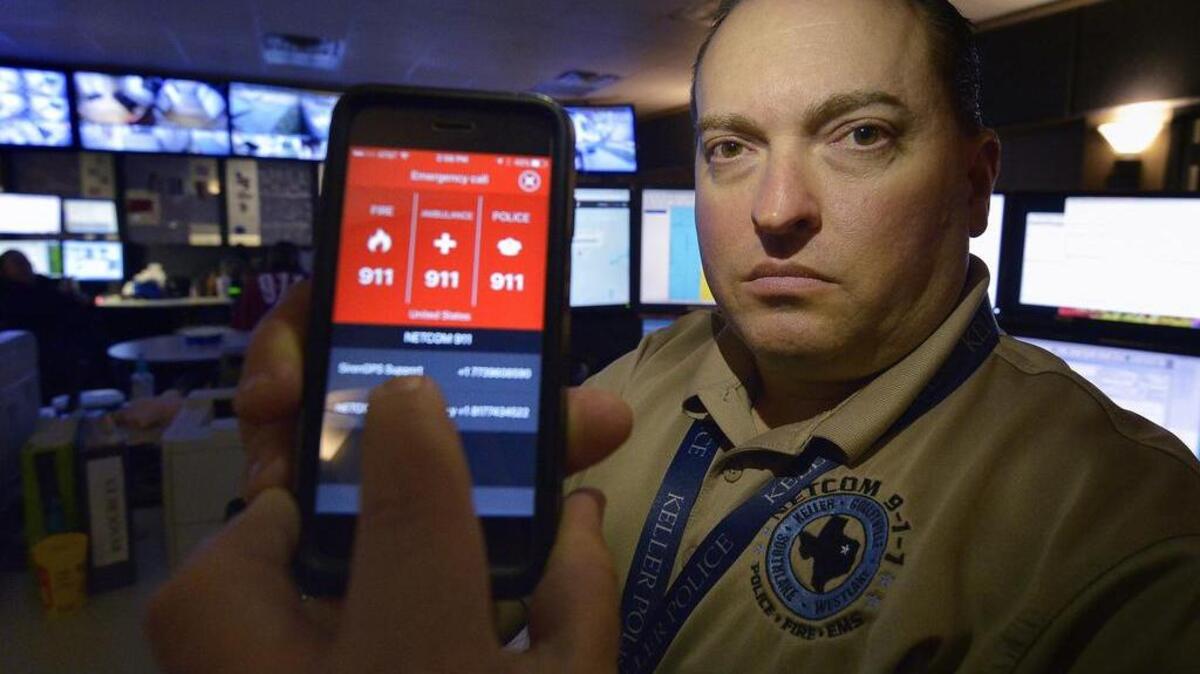Warren Dudley, NETCOM 911 manager, tests the SirenGPS app at a Keller police station.