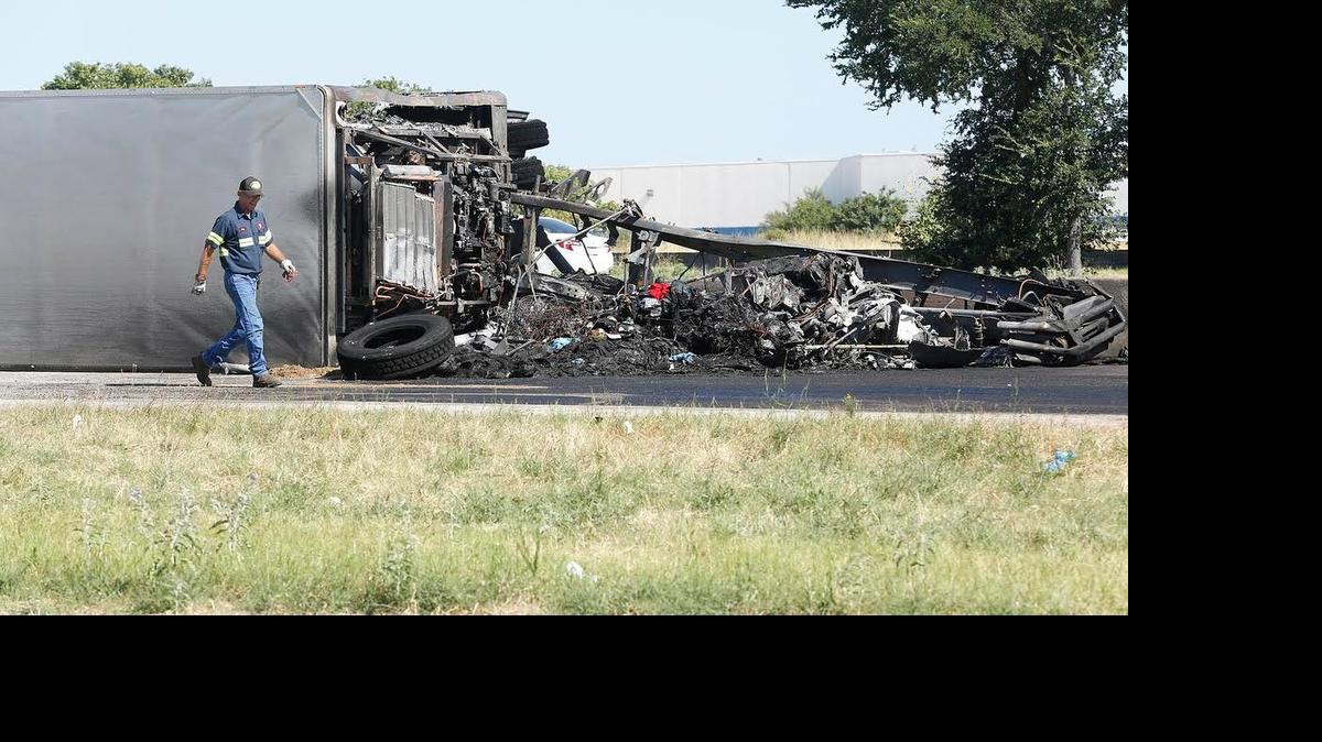 
Workers prepare to remove debris from a burned tractor trailer truck at the scene of a fatal wreck on Texas 183 in Irving Sunday. The truck driver died at the scene. A fire truck was struck by the tractor trailer truck, injuring three firefighters.
