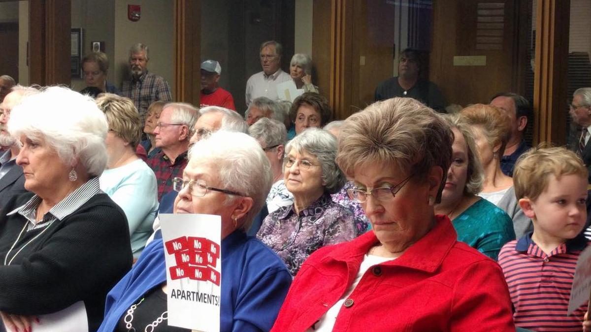 Residents packed the Bedford City Council chamber Tuesday night with signs that said “No Apartments.”