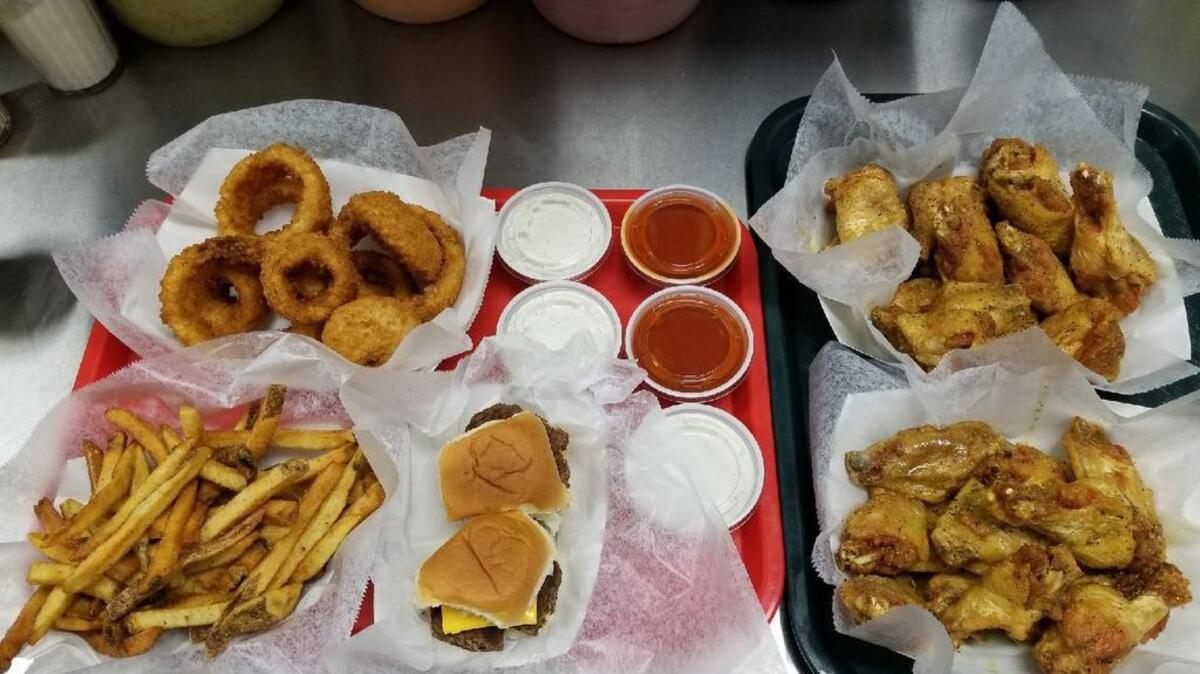 Wings come in seven different flavors, with fries and onion rings as popular sides.