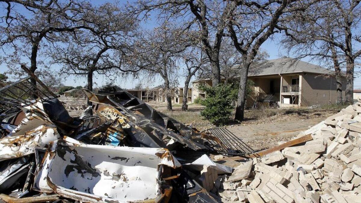 Run-down apartment complexes are demolished to make way for the Euless Midtown development at Texas 10 and Farm Road 157 in Euless on Thursday.