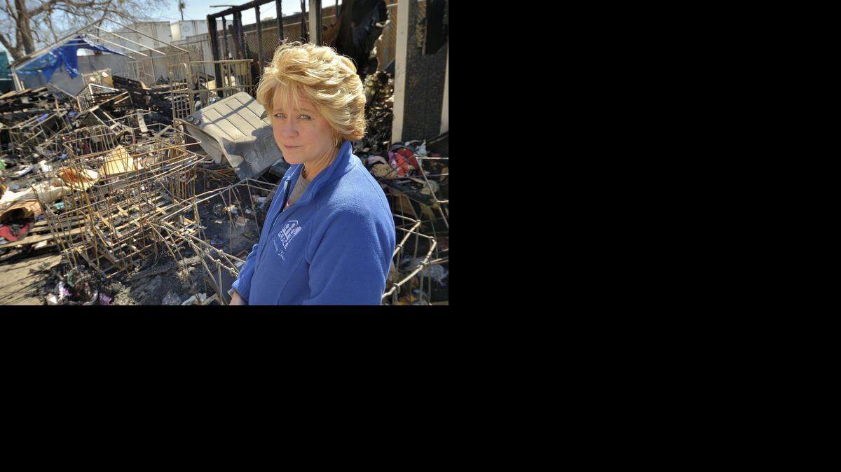 
Shonda Schaefer, executive director, looks at the damage Friday from an overnight fire at the GRACE donation warehouse in Grapevine. The fire destroyed about 50 percent of the donation items. One person had been arrested in connection with the suspected arson as of late Saturday, authorities said.
