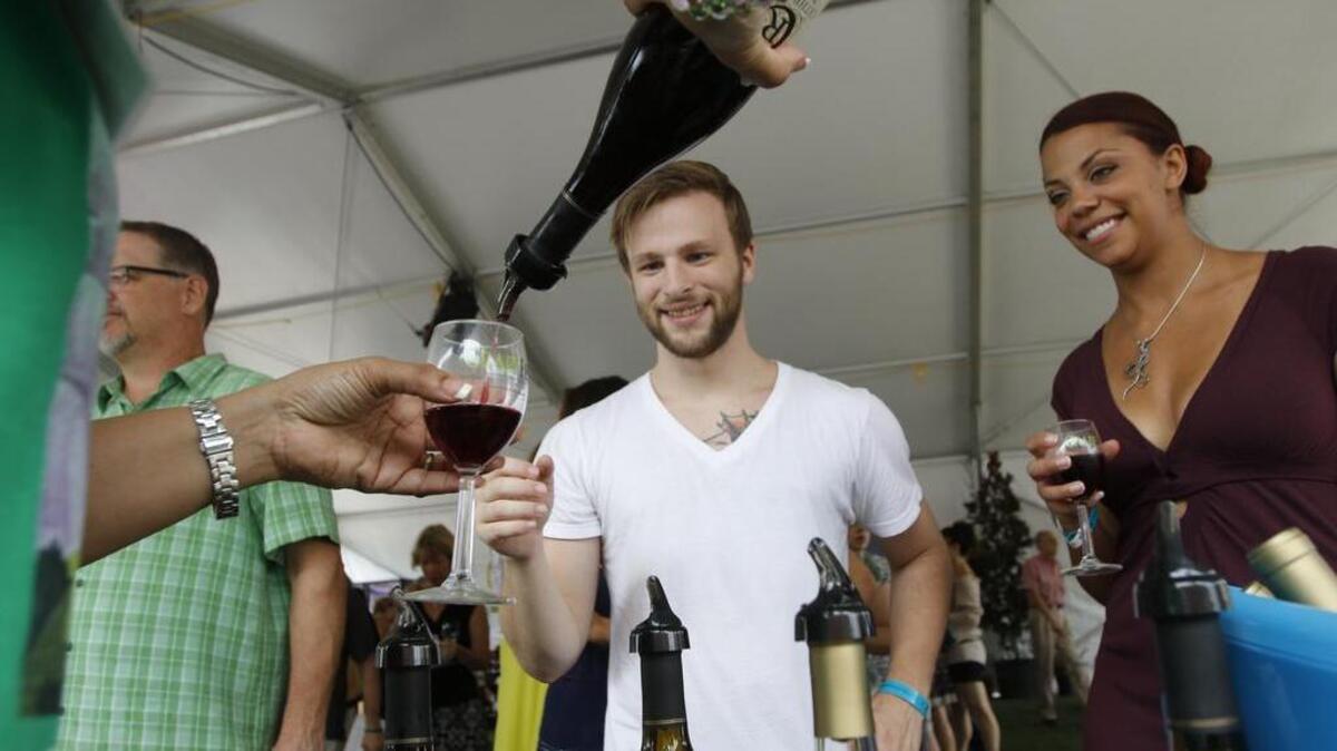 
Tyler Whiteman has a glass of wine with Alyssa Davis at Grapefest in Grapevine on Sept. 20. 
