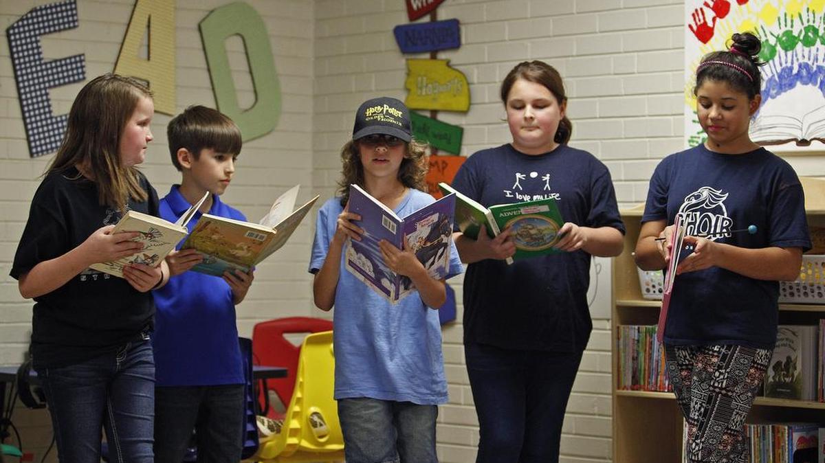 Stonegate Elementary students Harlie Wallace, Noah Ramirez, Jayden Torres, Erin Casey and Liliana Olivera read for guests last week during the dedication ceremony for a new Reading Oasis. United Way of Tarrant County is bringing the centers, which feature comfortable chairs, plenty of books and listening stations where children can listen to audiobooks, to several elementary schools.