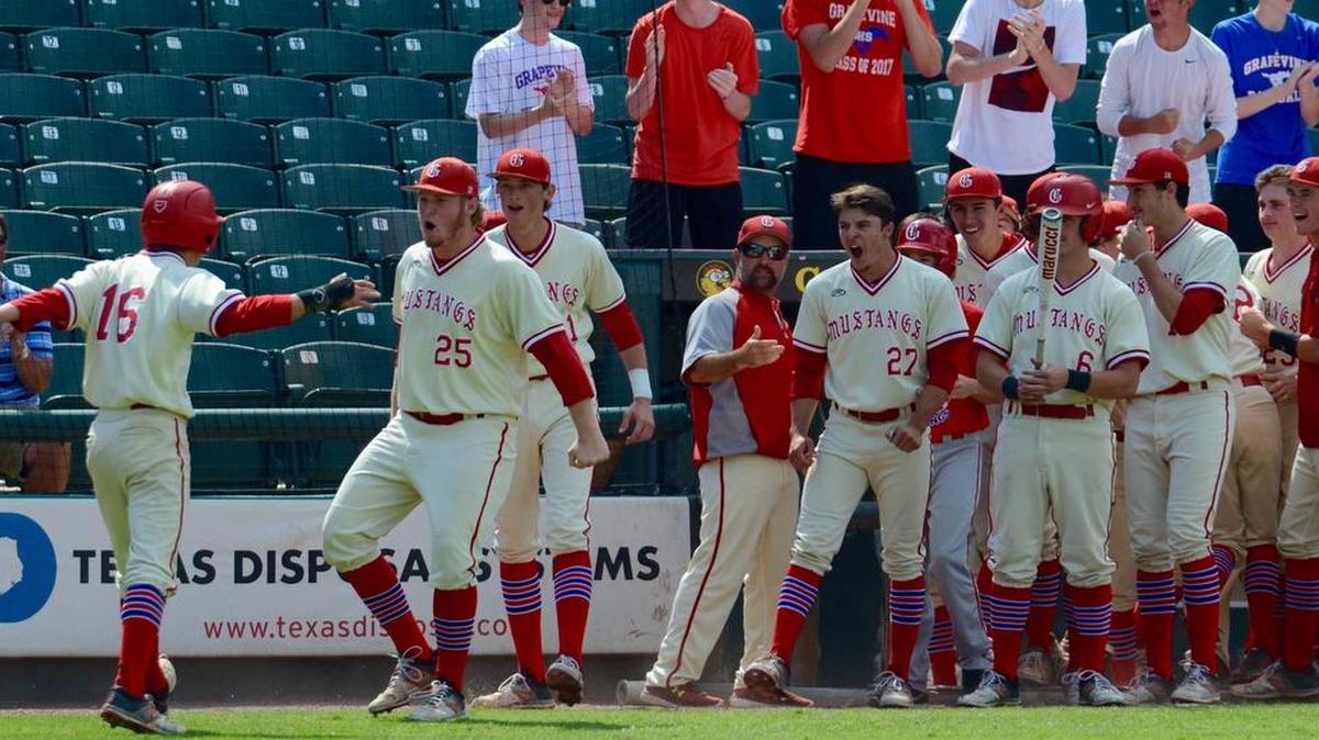 Grapevine teammates await London Green after he scored from first base in the first inning to give Grapevine a 3-0 lead against Whitehouse in the state tournament.