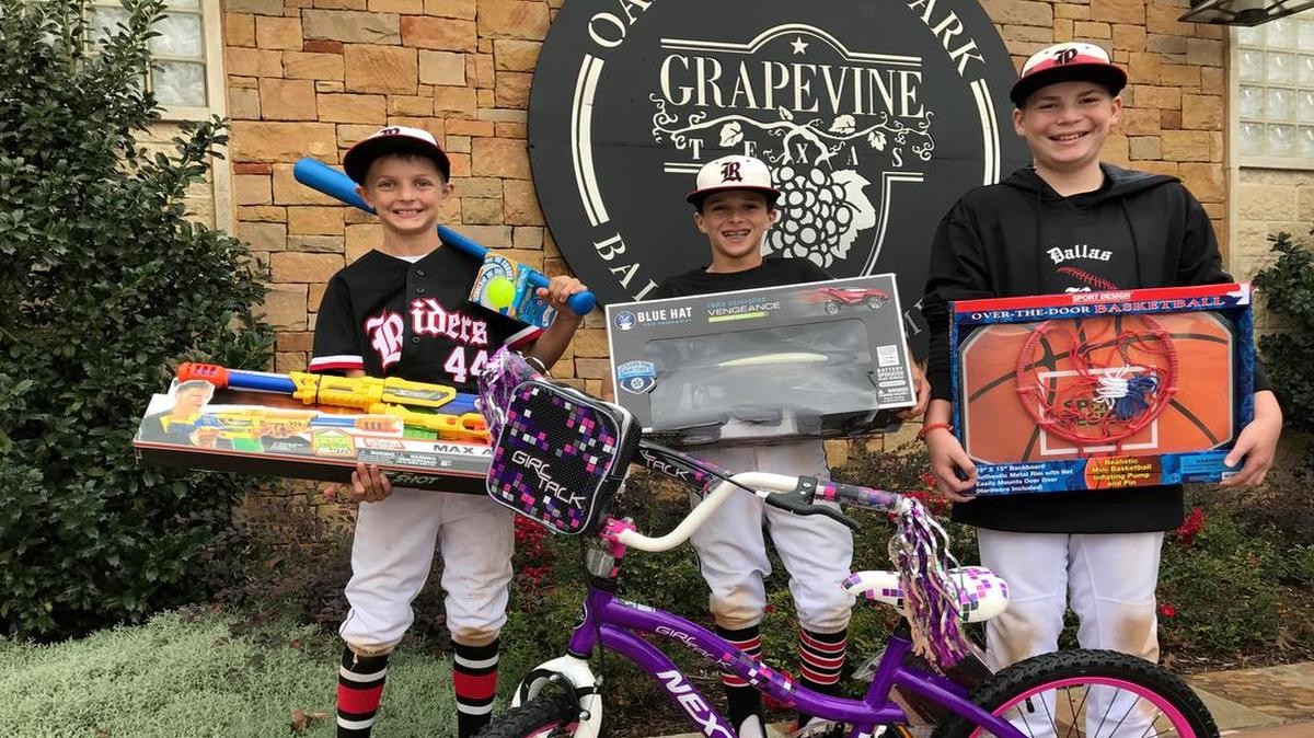 From left: Dasan Hill, Sammy Kelley and Matthew Mitchell with toys donated at annual baseball, softball tournament.