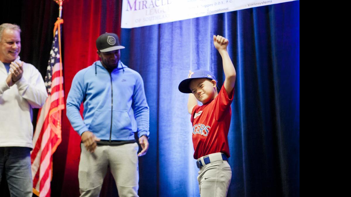 
Wyatt Kwentus (right), a player in the Southlake Miracle League, shows off the new uniform that will be used league-wide, on April 28, 2015 at Hilton Southlake. Rangers shortstop Elvis Andrus and former player Steve Buechele (far left), are seen in the background. The newly-founded Southlake Miracle League unveiling its new uniforms. The league will begin its first season this fall.
