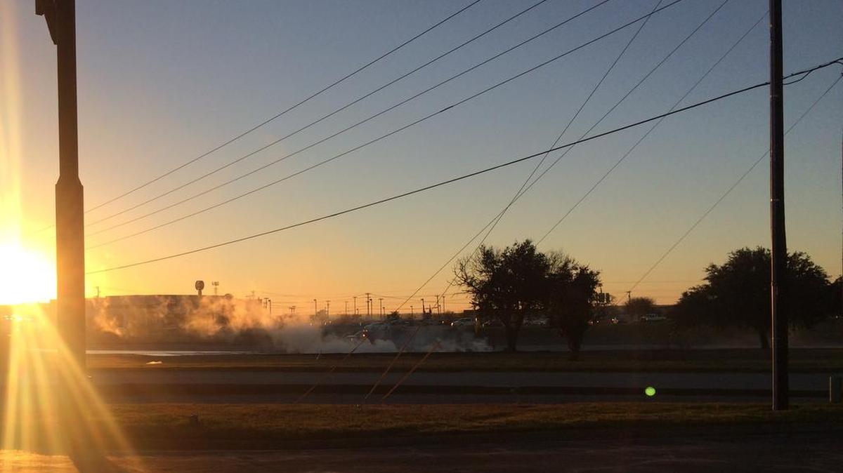 Smoke rises from a burning RaceTrac tanker truck that crashed in the 100 block of southbound Northeast Loop 820 on Dec. 19. Hurst police are looking for people who saw the crash.