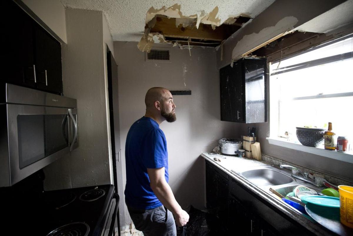Nathan Barnes shows the kitchen where the ceiling collapsed at the Linbrook apartments in Bedford in August.