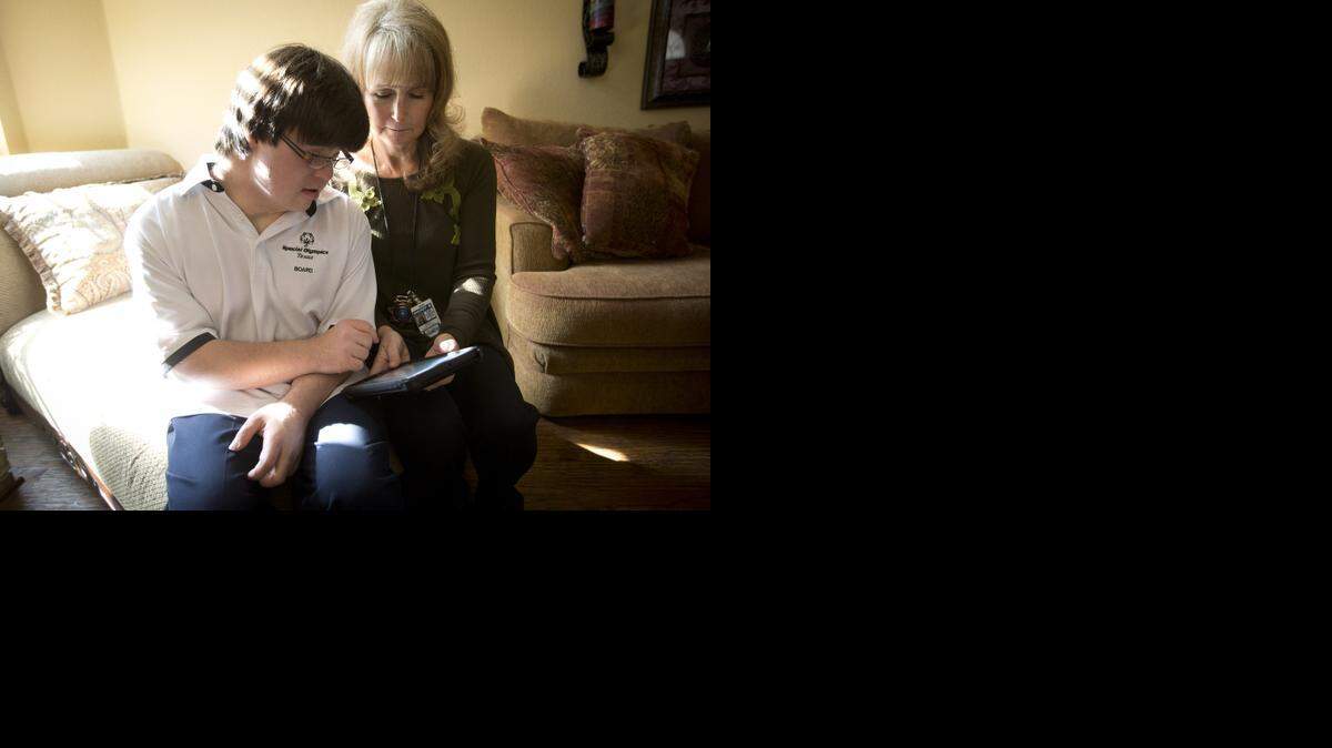 
Colby Bannister of North Richland Hills received an iPad recently from a class of Grand Prairie police recruits. He and his mother work together with the tablet, which he uses instead of index cards for speeches.
