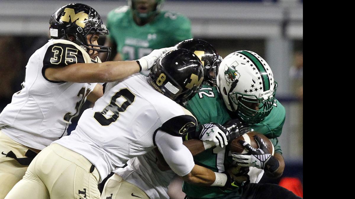 
Zach Farrar, right, fights Mansifeld defenders in the playoffs last season.
