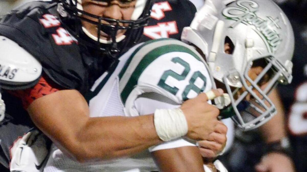 
Trinity's Devin Abdullah tackles De La Salle's Antoine Custer in the first game of the season.

