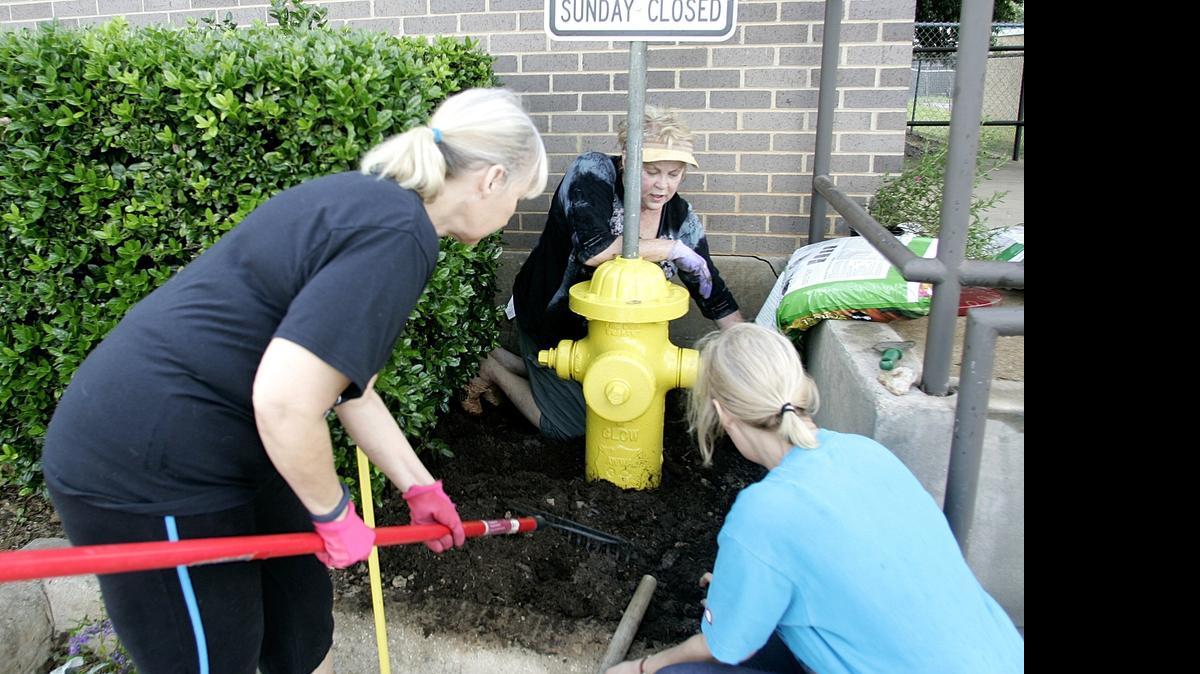 
Denice Seal, Patrice Kleycas and Jeanne Green beautify an area with flowers and plants outside the Bedford Animal Shelter on June 13. Plantings and an interior paint job spruced up the building. 
