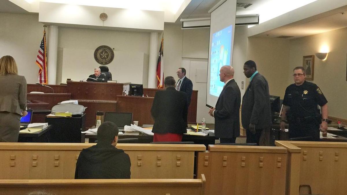 Robert Williams, at right in teal shirt, is charged with capital murder in the death of his 3-year-old daughter in 2013.