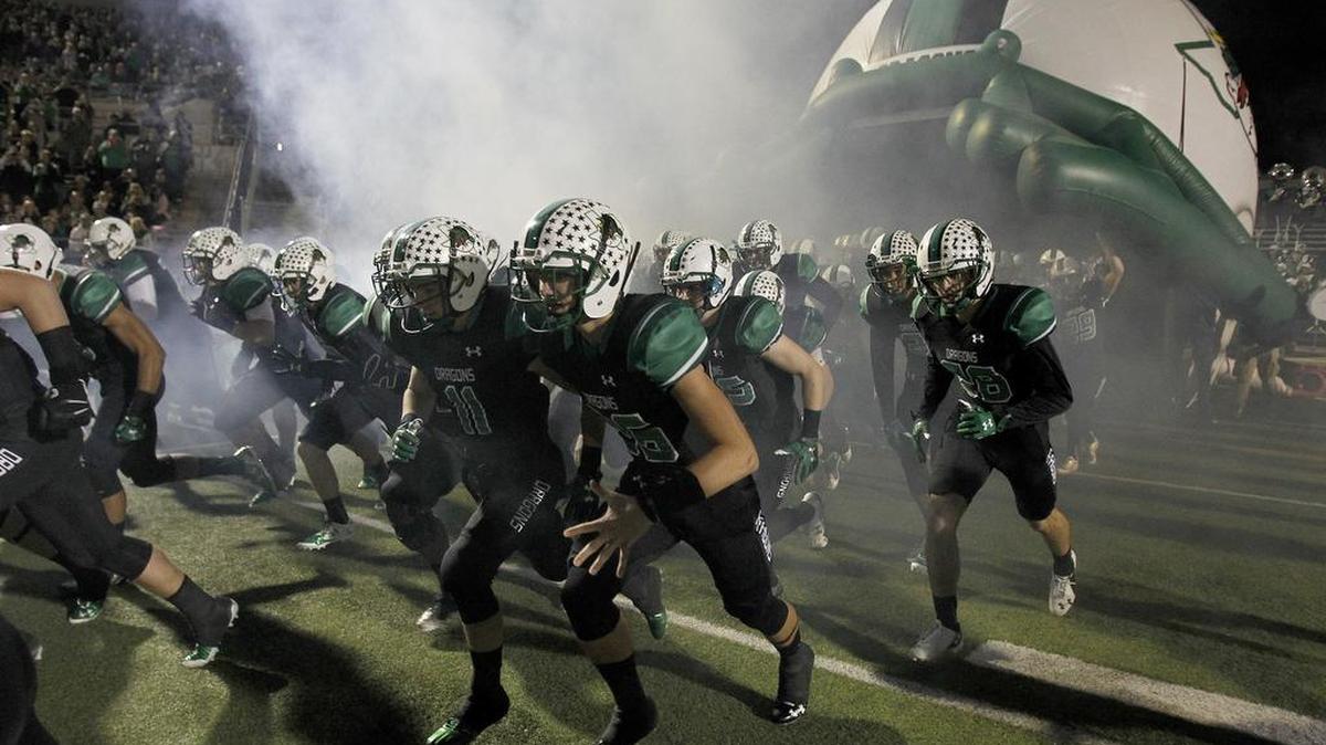 When the Southlake Carroll Dragons take the field Friday night in Broken Arrow, Okla., they’ll do it without cheerleaders, a marching band or the drill team.