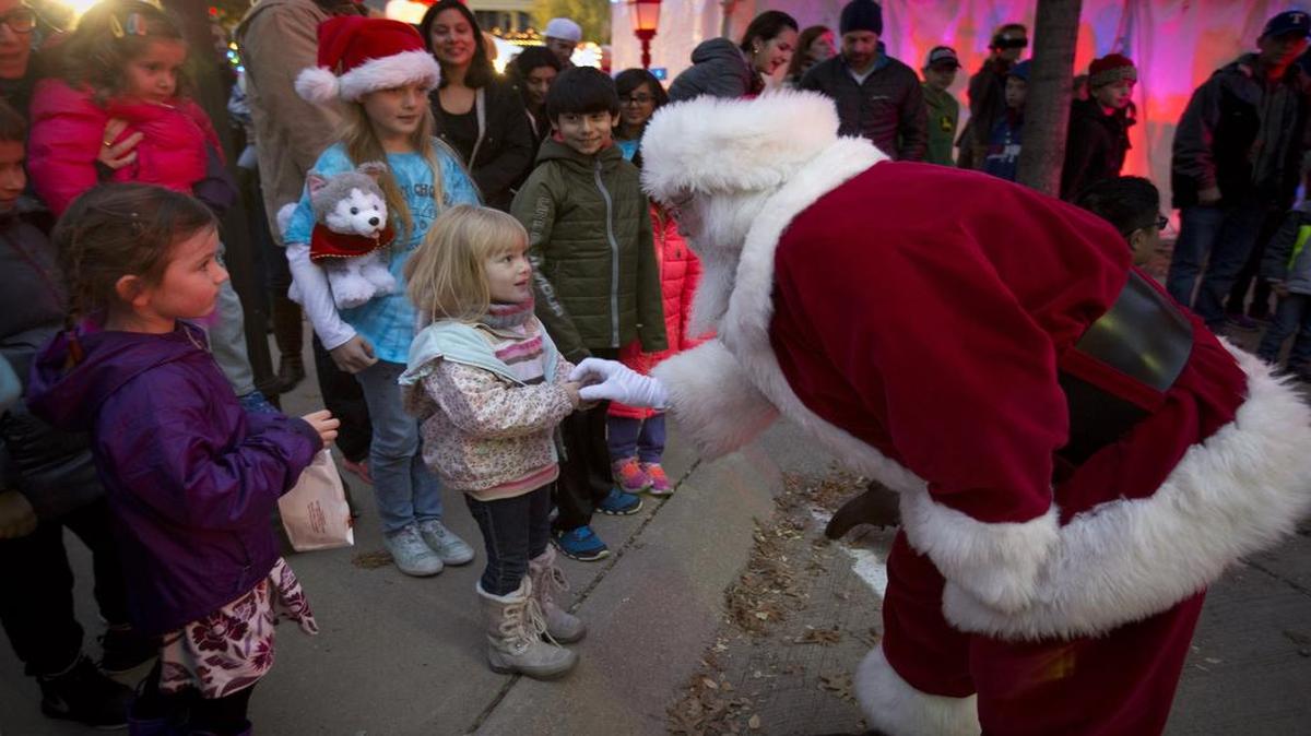 Santa greets children as he arrives to help light the Colleyville Christmas tree and several trees decorated by local organizations.