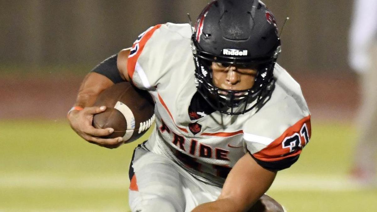 Colleyville Heritage's Mario Ortiz escapes Dunbar's Anterrion Dixon in last Friday’s win.
