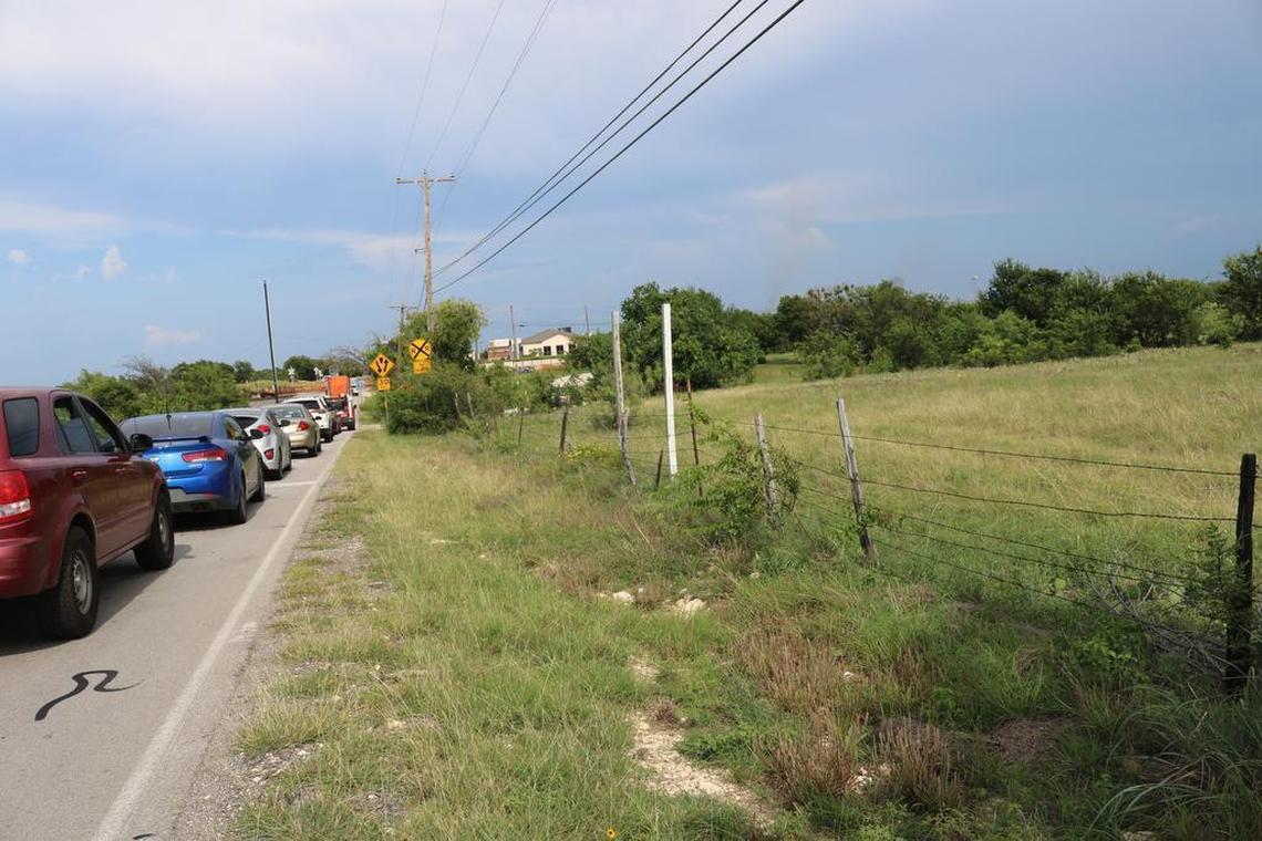 Northwest trustees recently approved the purchase of 140 acres bordered by Avondale Haslet Road, at far left, to the north and railroad tracks on the east for a future high school and middle school. Here, traffic backs up in late afternoon on July 7 while train cars are moved from a nearby BNSF facility.
