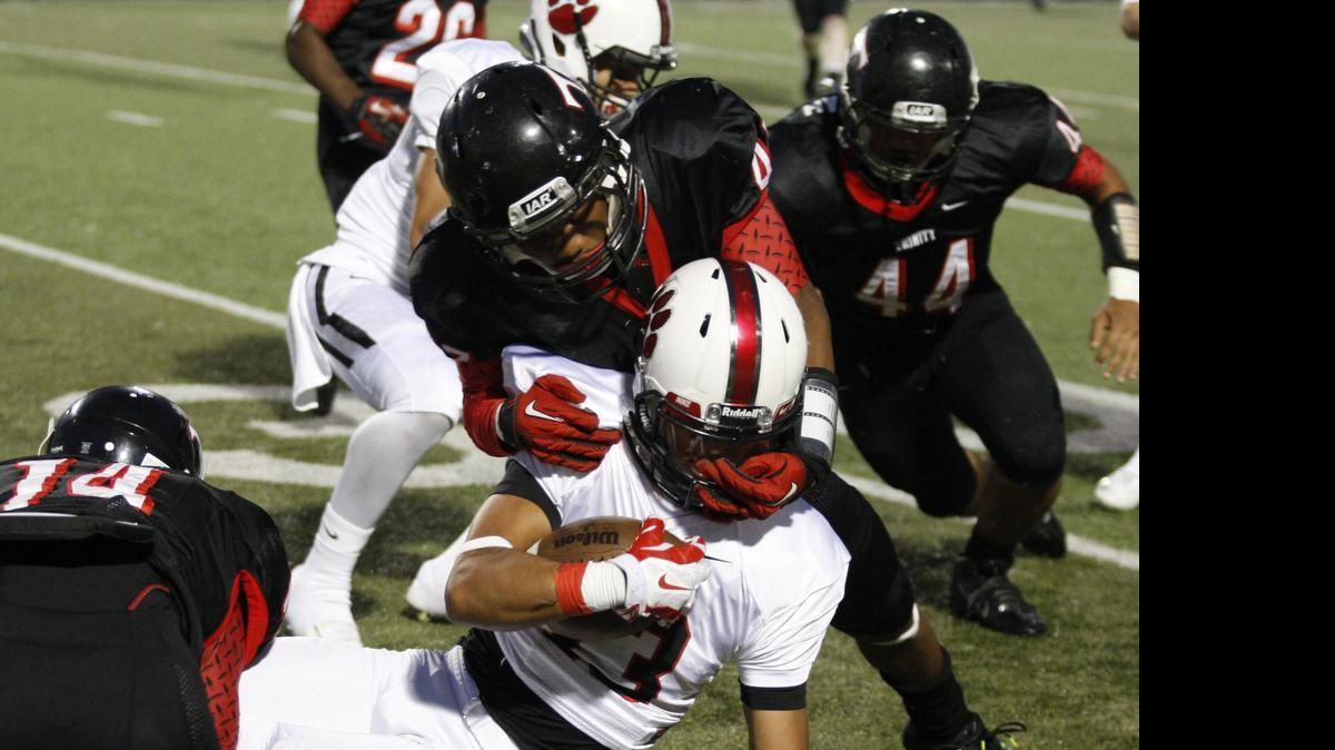 
Trinity defender A.J. Jackson tackles Colleyville wide receiver (13) Kevin Salinas in district competition last season.
