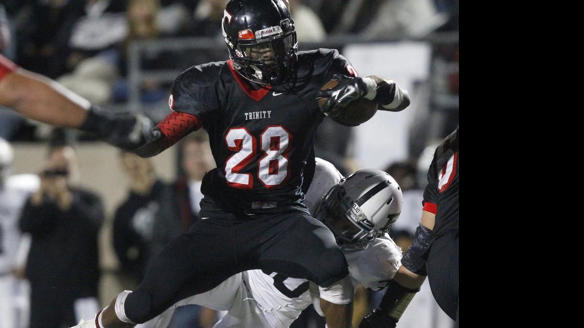 
Trinity running back Ja'Ron Wilson evades tackles last year against Odessa.
