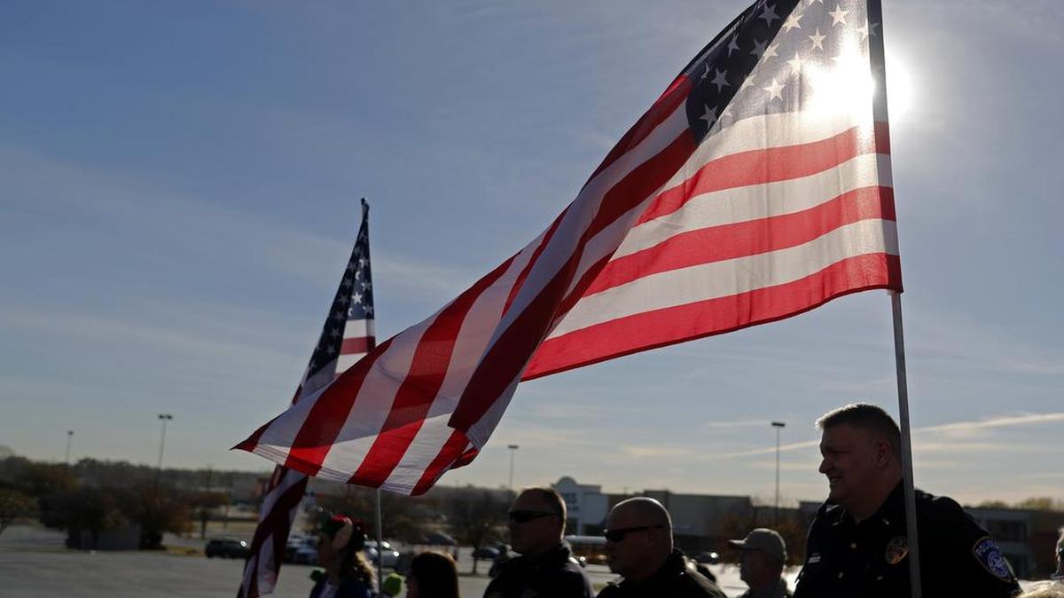 First responders and volunteers lined up to greet family who has lost a military family member during the Snowball Express at iT'Z Family Food and Fun in Euless Dec. 11.
